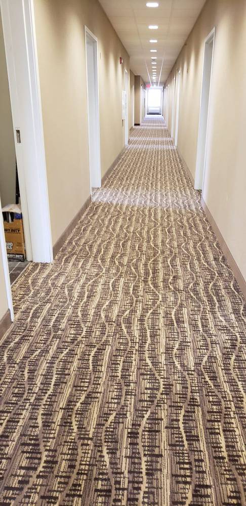 Commercial corridor with patterned carpet flooring