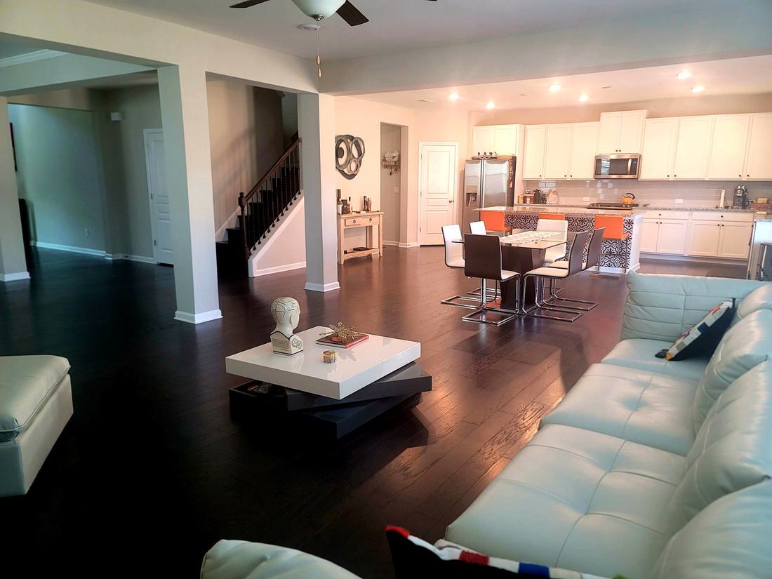 Open living and dining space with finished wood flooring