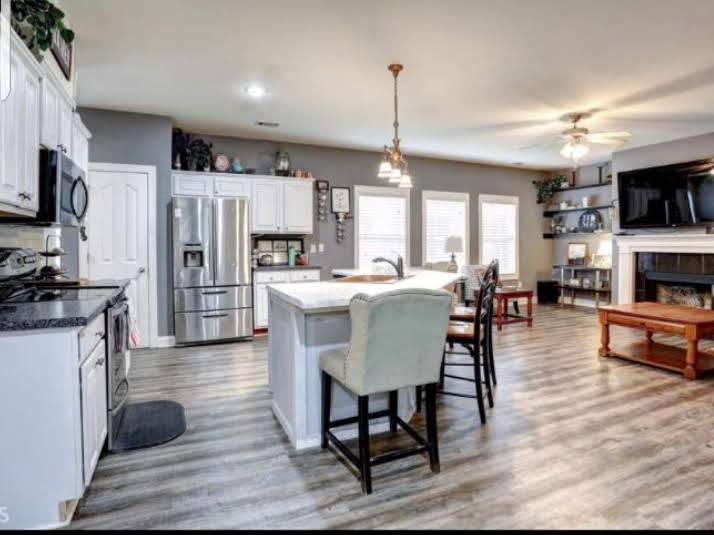 Open kitchen with finished wood-look plank flooring